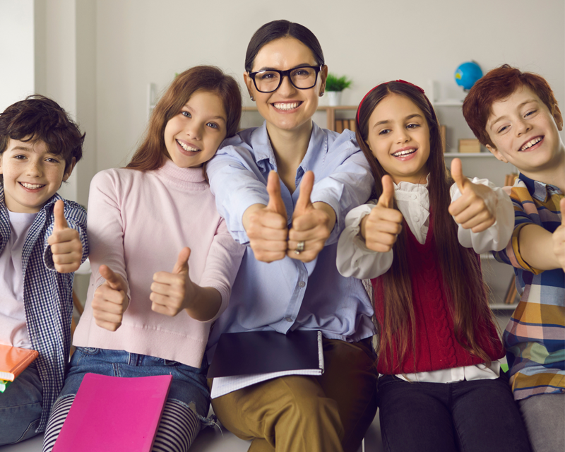 staff and students giving thumbs up